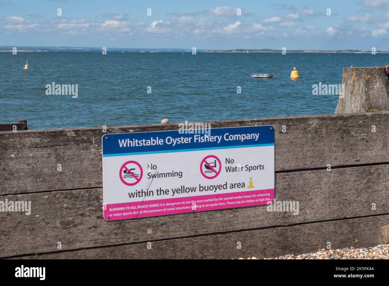 "Whitstable Oyster Fishery Company" sign warning people about swimming