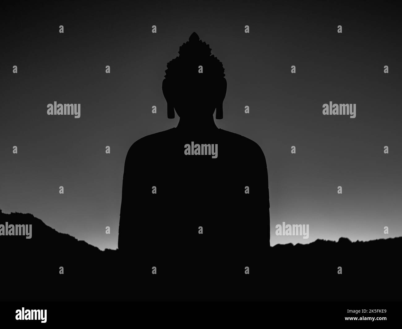 The dark silhouette of the Buddha statue - great for a wallpaper Stock Photo