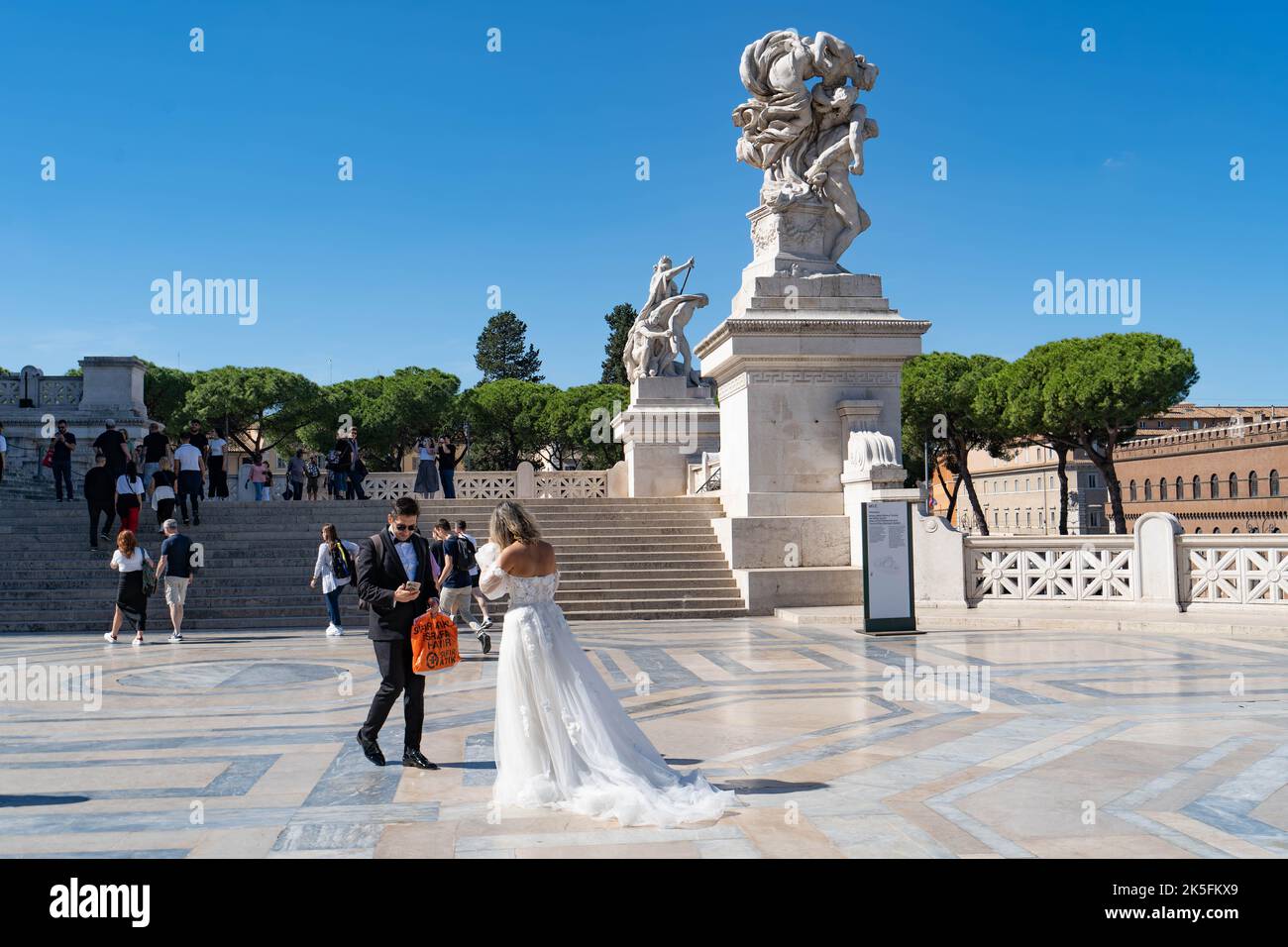 A couple in wedding clothes at The Victor Emmanuel II Monument, (Altare della Patria or Wedding Cake), Rome, Italy Stock Photo