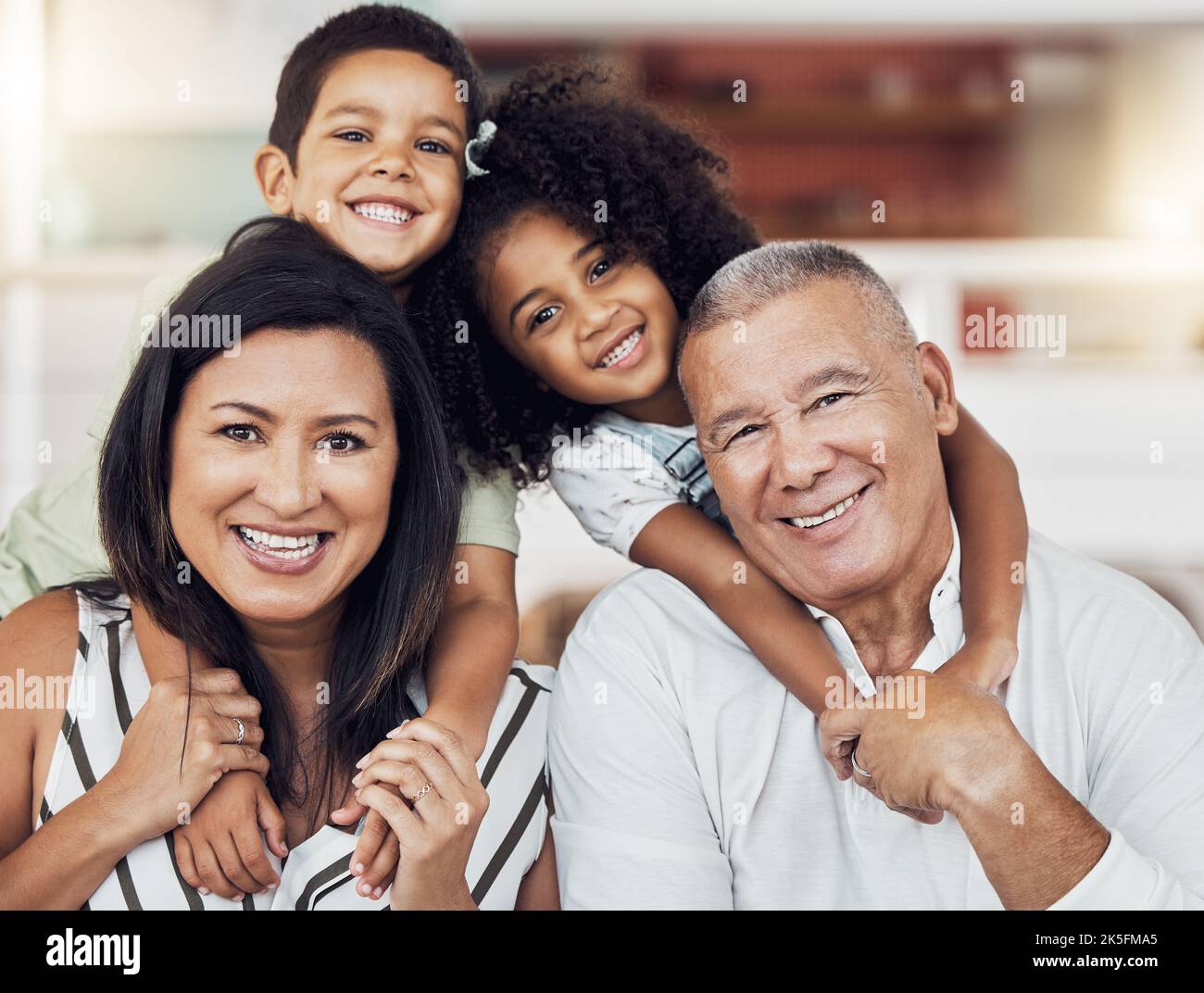 Portrait of happy kids, grandma and grandpa at home spending family time together. Grandparents babysitting girl and boy in Mexico. Senior man, woman Stock Photo