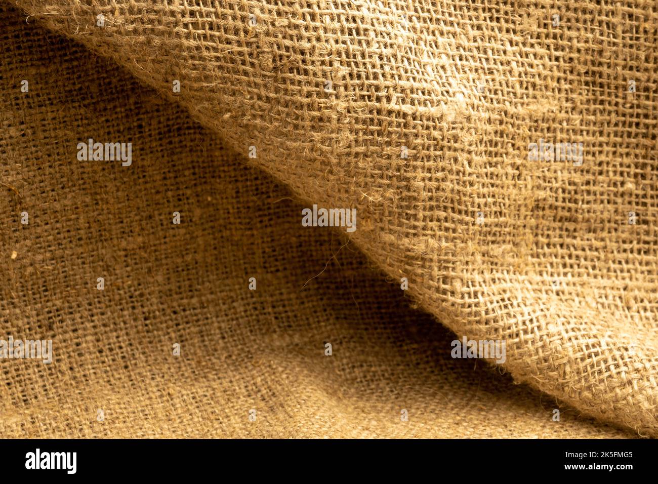 Homespun fabric with a rough texture. Close-up, selective focus. Stock Photo