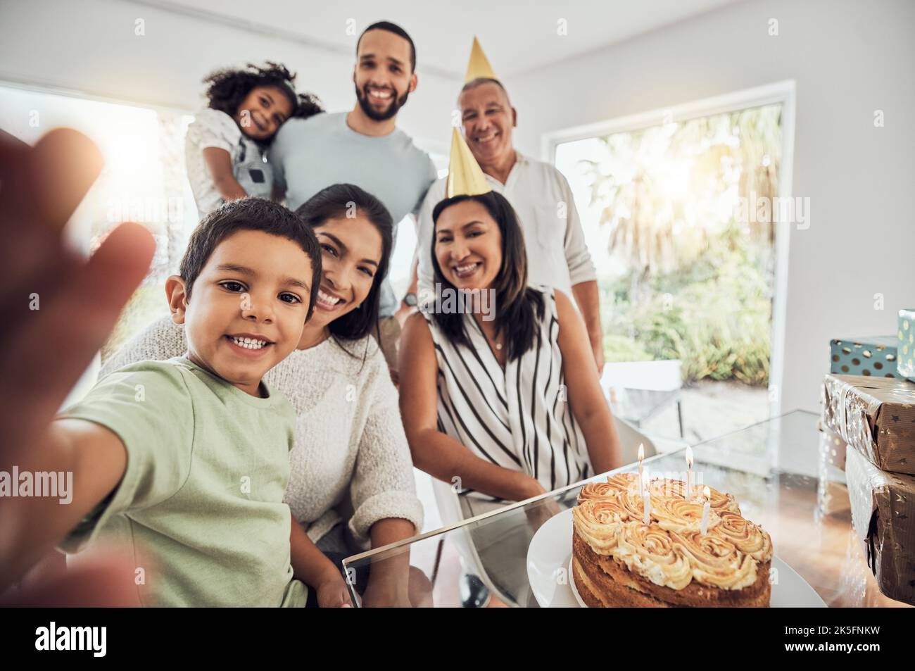Happy birthday cake, selfie and big family celebration in home with portrait smile for memory or social media post. Puerto Rico people and children at Stock Photo