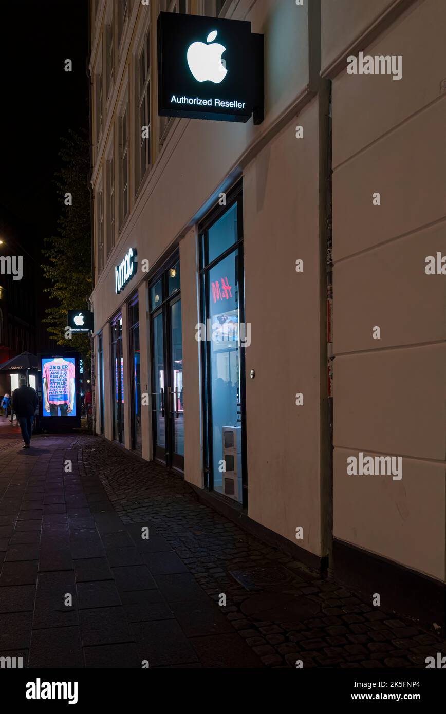 Copenhagen, Denmark. October 2022. External view of the Apple brand store by night in the city center Stock Photo