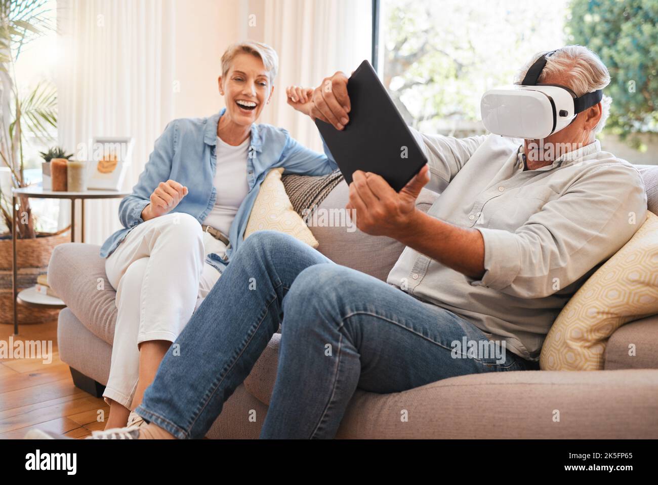 Virtual reality, 3d and digital gaming senior couple online in living