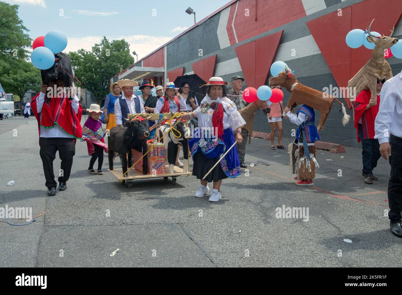 Marchers in traditional clothing and with wooden animal statues.at the Ecuadorian Parade NYC 2022 in Queens, New York. Stock Photo