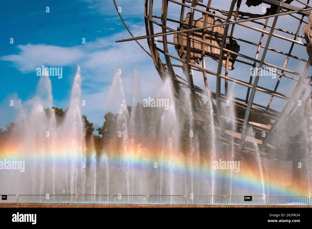 A visible rainbow seen in the fountains surrounding the Unisphere in