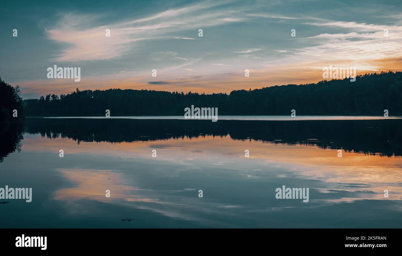An aerial view of a beautiful lake near the forest at sunset Stock ...