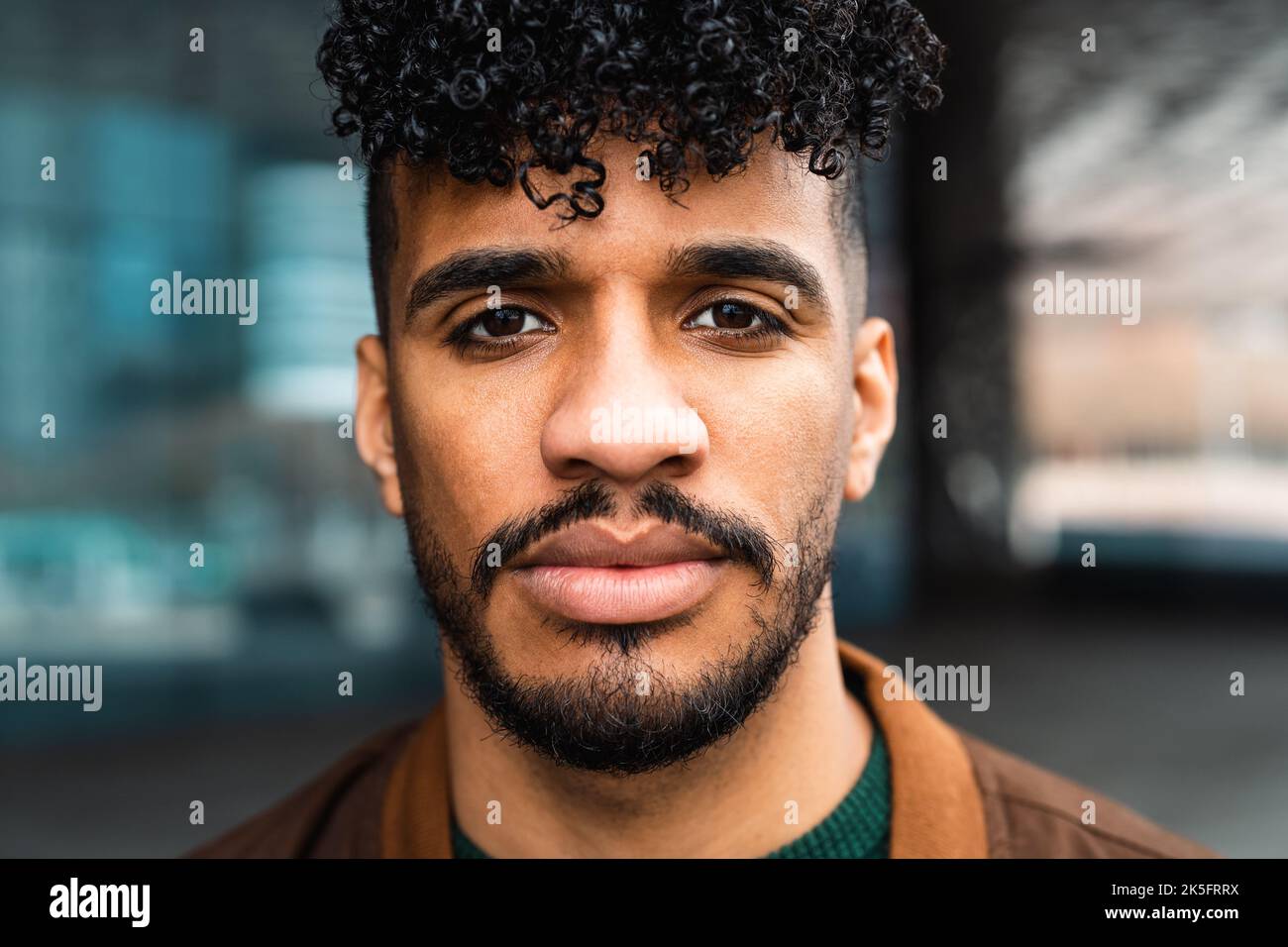 Young Latin man portrait looking in front of camera Stock Photo