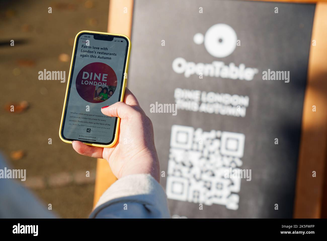 EDITORIAL USE ONLY A passerby uses QR code to book OpenTable's popup