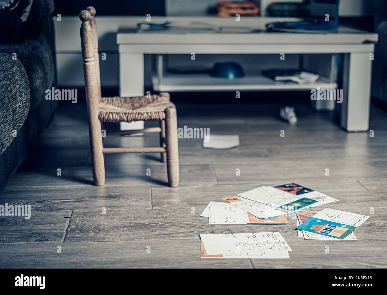 empty chair and papers on the floor Stock Photo