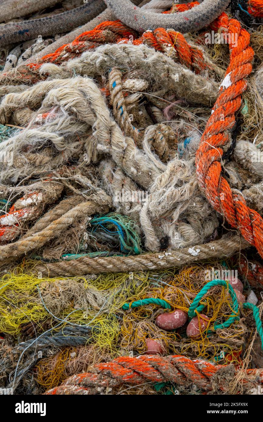 tangled fishing ropes and nets in an abstract composition, plastic nets and fishing gear, plastics used for fishing tackle, trawlers fishing gear. Stock Photo
