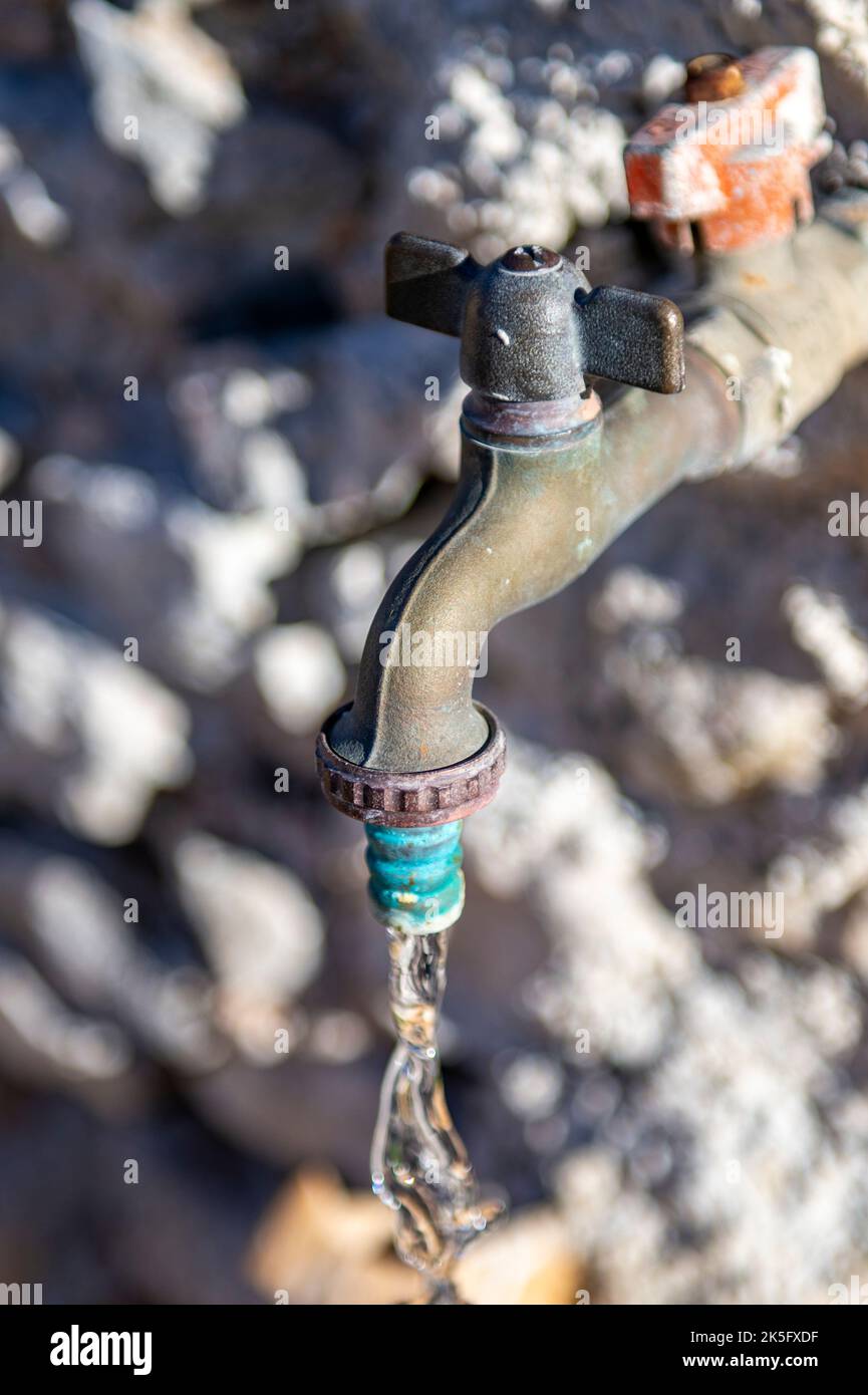 outside tap running water, wasting water, tilities, drought, water