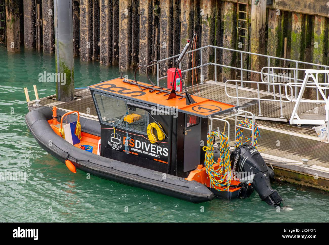 divers rib boat alongside in portsmouth harbour, commercial divers vessel tied up in port at portsmouth uk Stock Photo