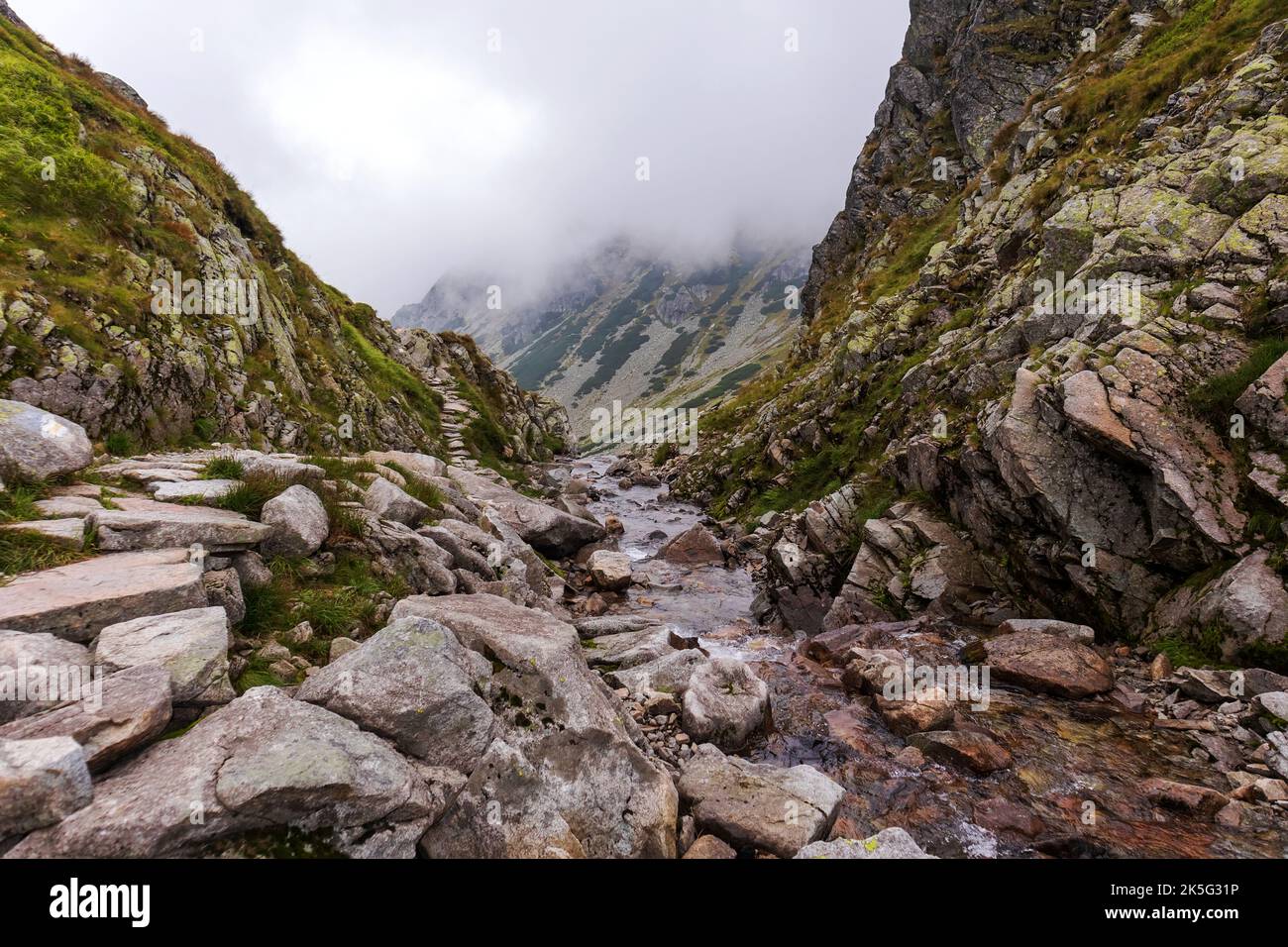 Impressive landscape with large grey-brown mountains in the Polish Tartars with a rocky hiking path Stock Photo