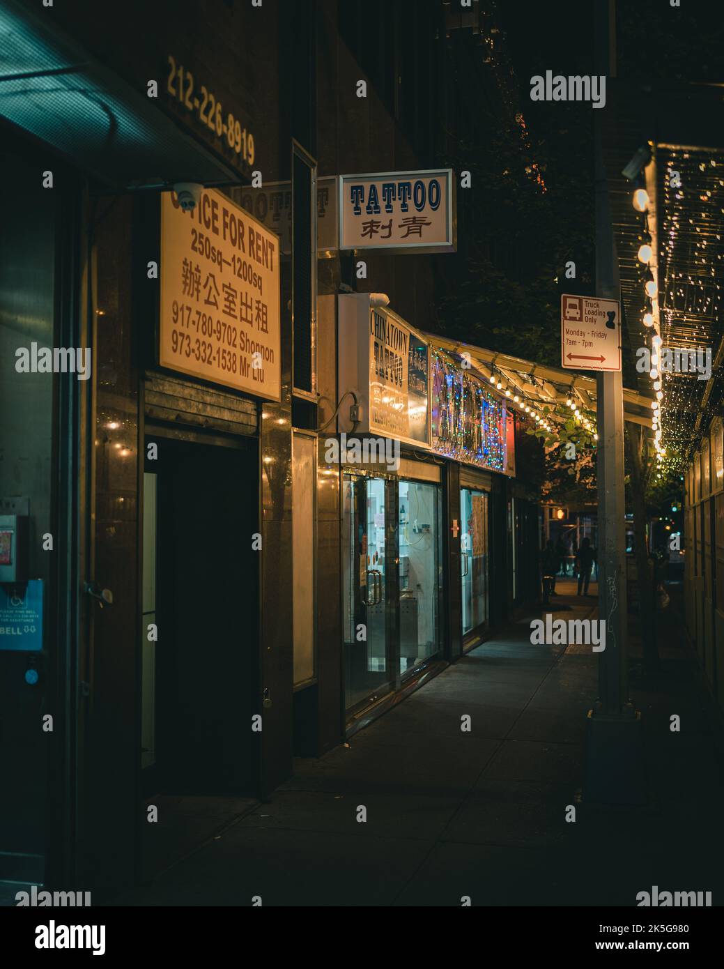 Tattoo sign at night in Chinatown, Manhattan, New York Stock Photo - Alamy