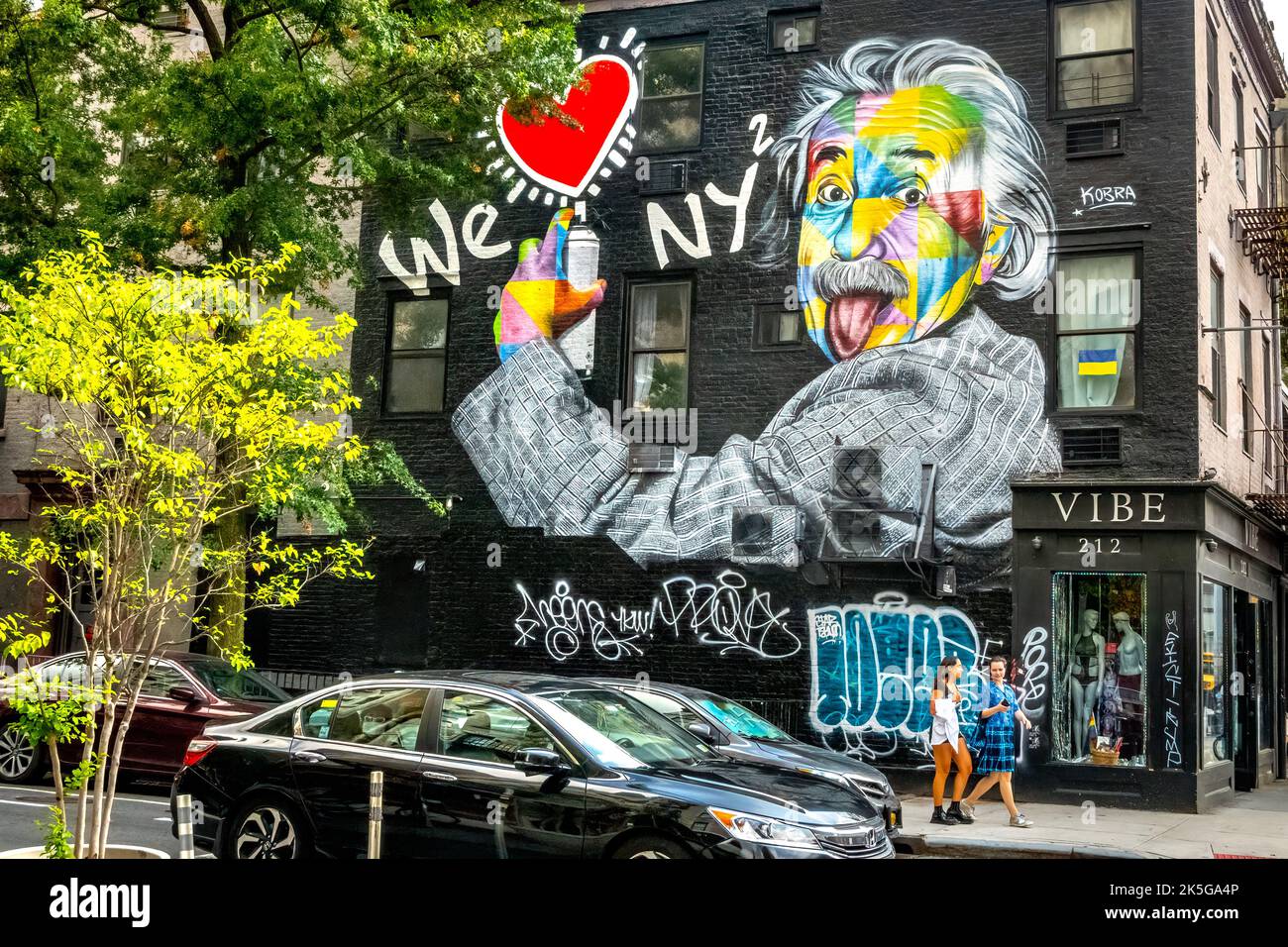New York, USA. People walk by a graffitti of Albert Einstein in New York City done by Brazilian artist Eduardo Kobra. Einstein won the Nobel Prize for Stock Photo
