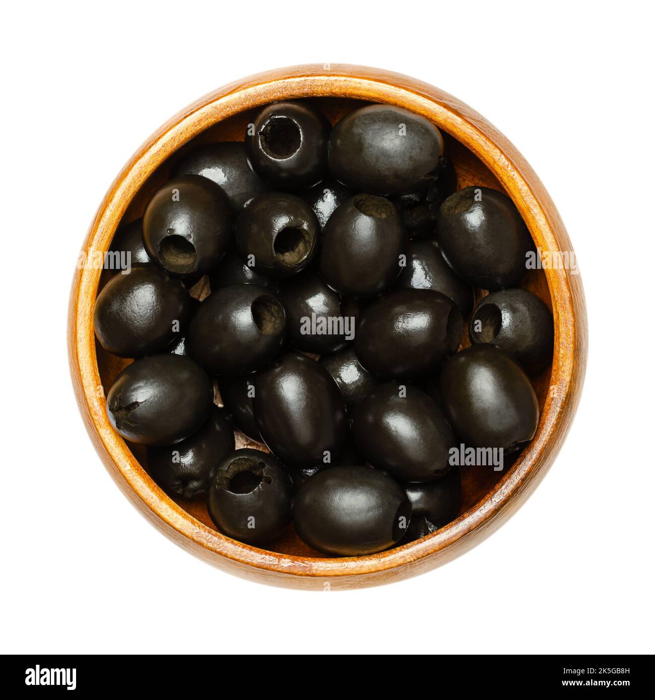 Hojiblanca, pitted black olives, in a wooden bowl. European olive, Olea europaea, a cultivar from Lucena in Spain, mainly grown in Andalucia. Stock Photo