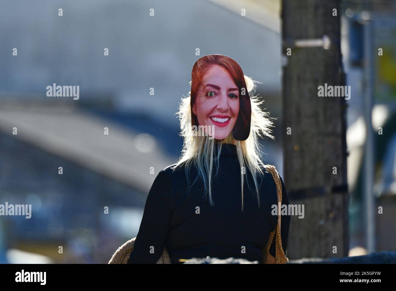 Cheddar, UK. 08th Oct, 2022. A person with friends are seen in Cheddar Gorge near shops wearing a LIZ TRUSS look alike mask on the back of her HEAD. Picture Credit: Robert Timoney/Alamy Live News Stock Photo