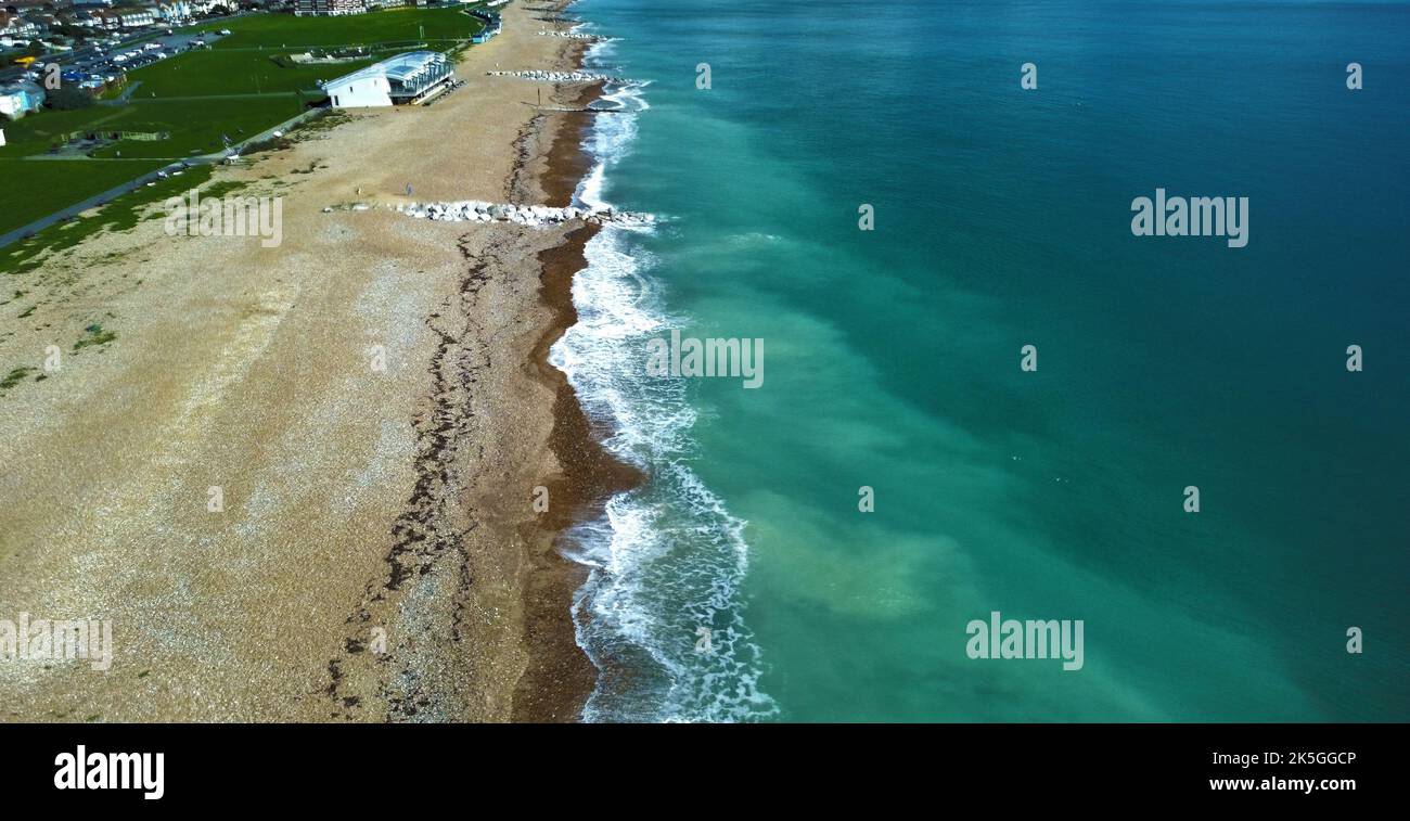 A bird's eye view of waves hitting the shoreline of a beach Stock Photo ...