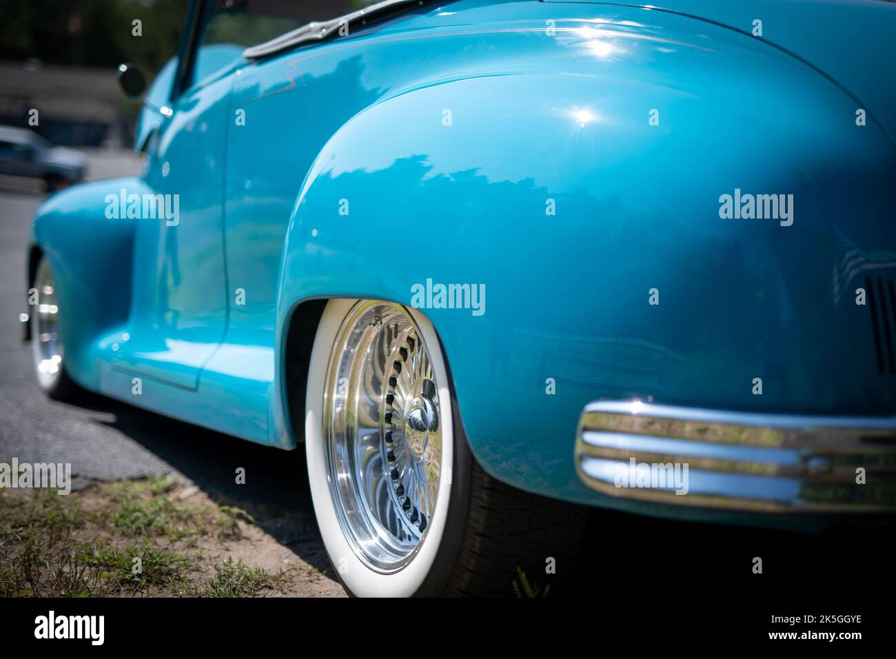NISSWA, MN  30 JUL 2022: Close view of back left vivid sky blue antique vintage convertible automobile with the top down at a car show in Minnesota in bright sunlight. Shallow depth of field focus. Stock Photo
