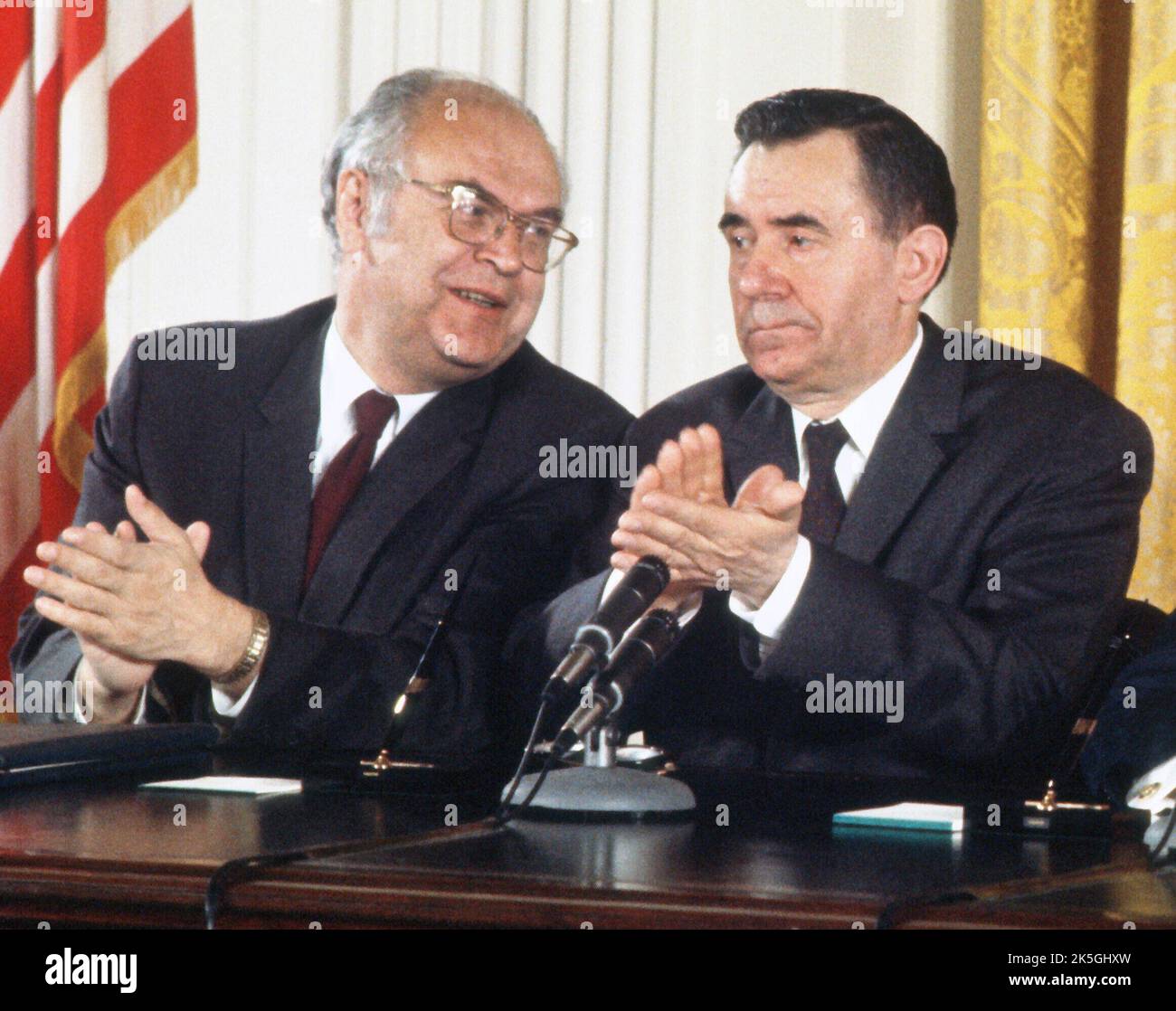 Soviet Ambassador Anatoly F. Dobrynin, left, speaks to Soviet Foreign Minister Andrei Gromyko, right, as United States President Richard M. Nixon makes remarks during a signing ceremony for the instruments of ratification of the SALT agreements between the Union of Soviet Socialist Republics (USSR) and the United States in the East Room of the White House in Washington, DC on October 3, 1972. The agreements intend to restrain the growth of the nuclear arsenals of both nations. Credit: Arnie Sachs / CNP Stock Photo