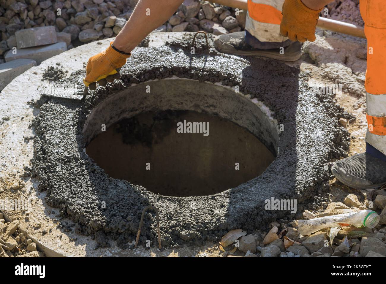 There is utility worker who is constructing pit for septic tank the sewerage manhole reconstructing sewage system Stock Photo