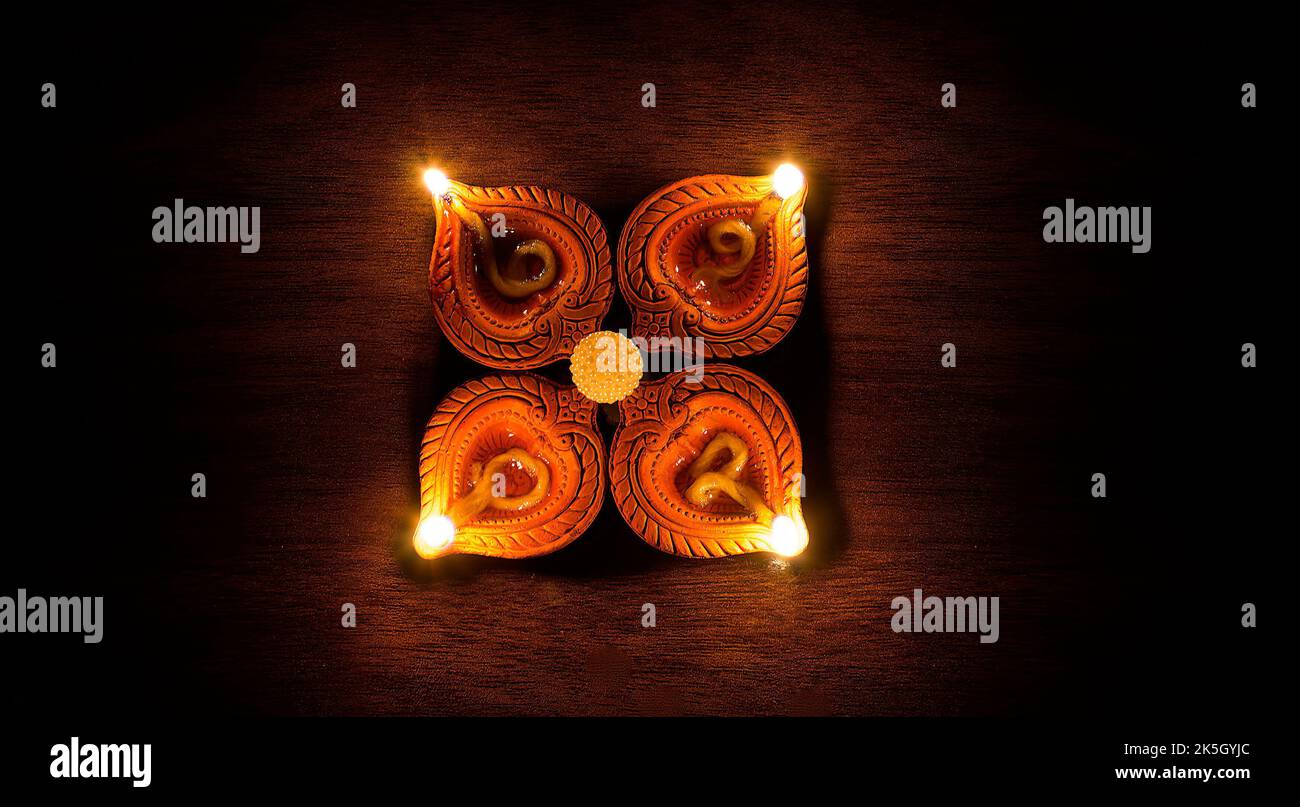Four lit oil lamps Stock Photo Alamy