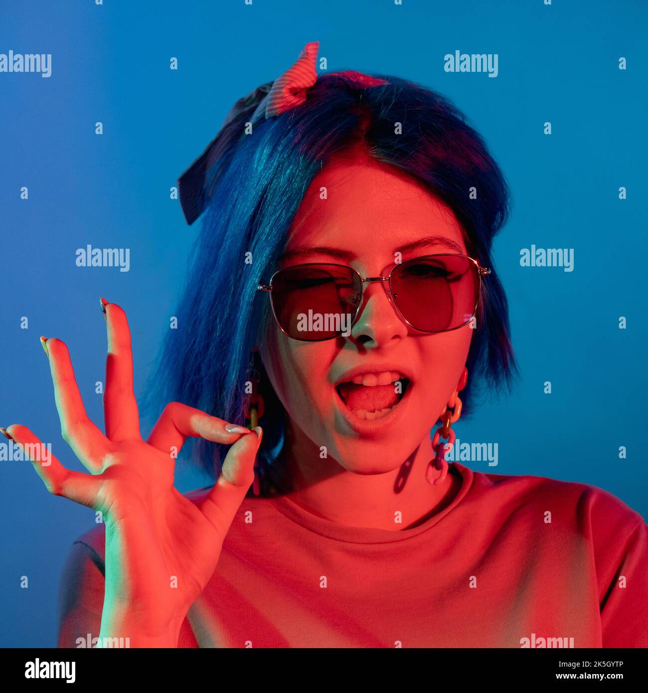 Okay gesture. Agreement sign. Good idea. Red neon light satisfied