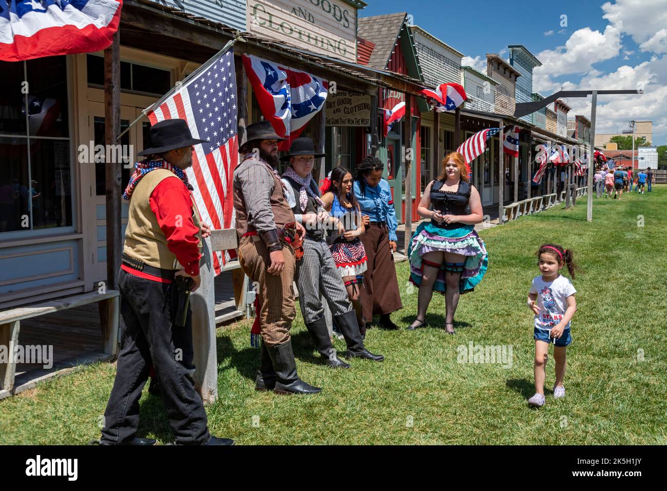 Dodge City, Kansas - Actors and one young tourist at Boot Hill Museum, which is decorated for a July 4th celebration. The museum preserves the history Stock Photo