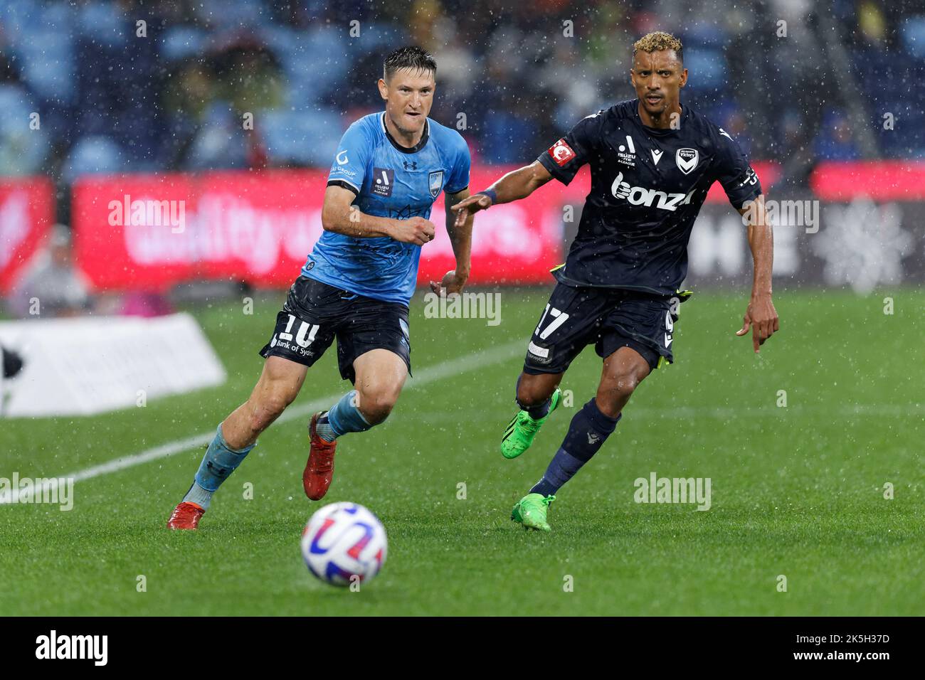 SYDNEY, AUSTRALIA - OCTOBER 8: Joseph Lolley of Sydney FC competes for the ball with Nani of Melbourne Victory FC during round one A-League Men's match between Sydney FC and Melbourne Victory at Allianz Stadium, on October 8, 2022 in Sydney, Australia Stock Photo