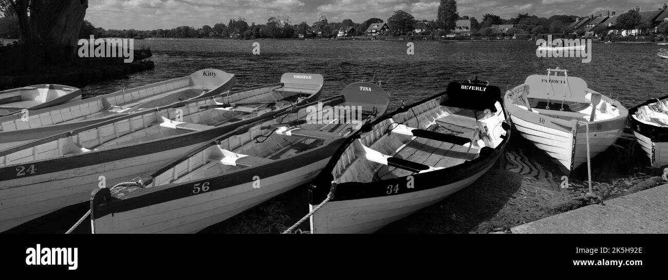 Colourful wooden rowing boats on the Mere at Thorpeness village