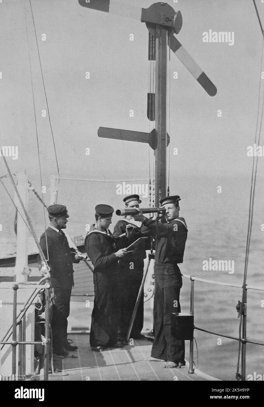 1891. Royal Navy signalmen on the bridge of the Admiral-class battleship, H.M.S. Camperdown, communicating with another ship by semaphore. At the time, Camperdown was the flagship of the Channel Fleet. Stock Photo