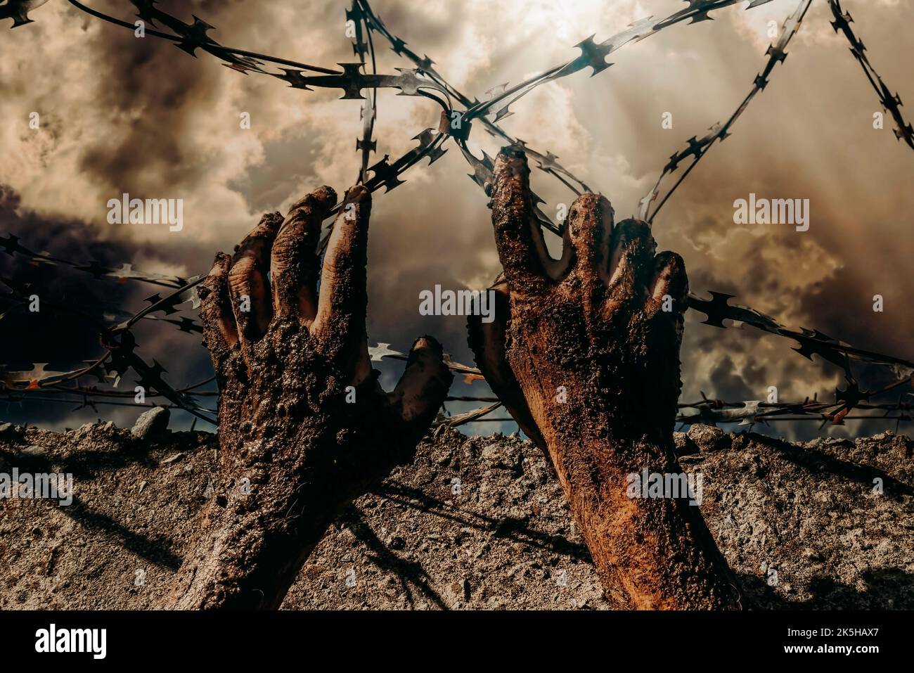 Jail break. Hands holding on to barbed wire on the wall of the prison