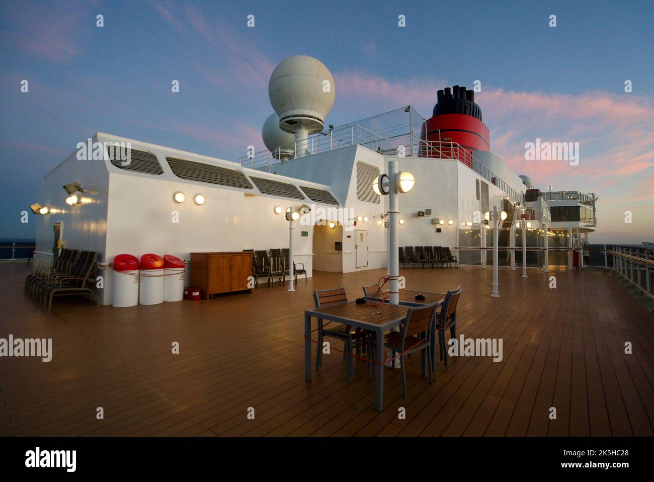 The view on the top deck of the Queen Victoria cruise ship, a Cunard cruise. Queen Victoria top deck at night, sunset. Stock Photo