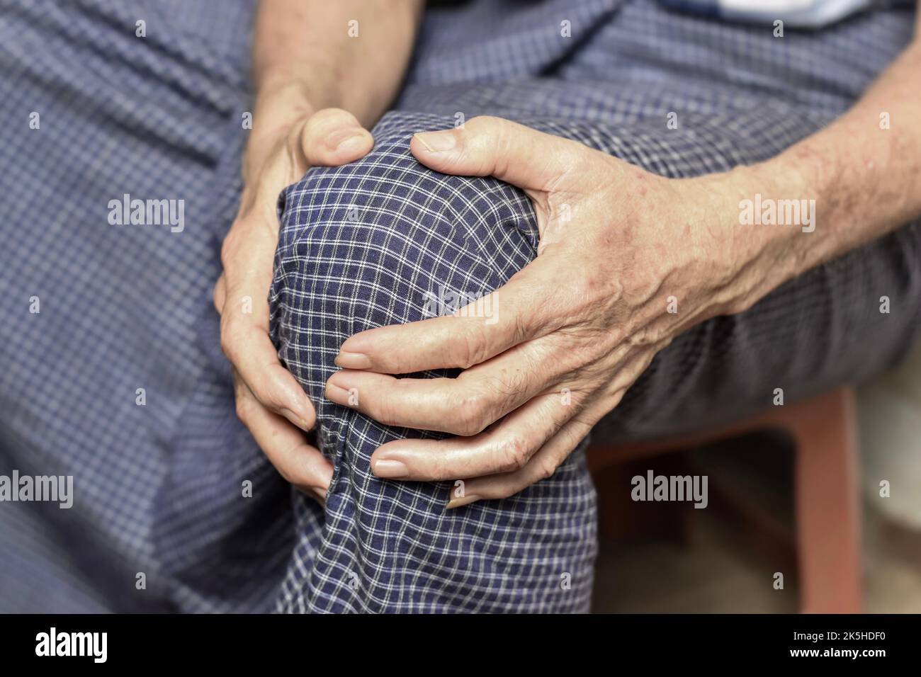 Knee joint pain in Asian Myanmar elder man. Concept of osteoarthritis