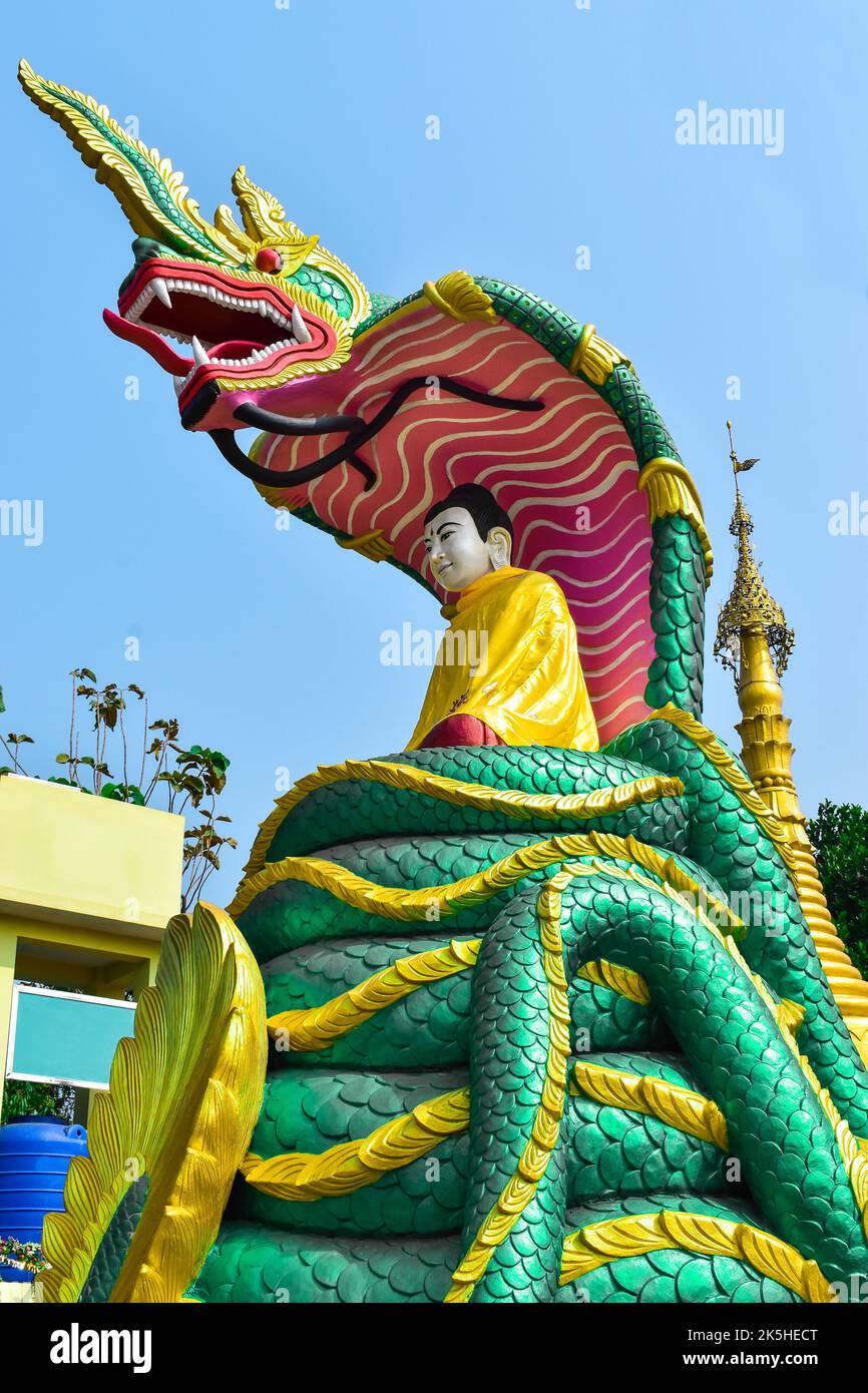 Myanmar Buddha statue seated on the Burmese green dragon. Stock Photo