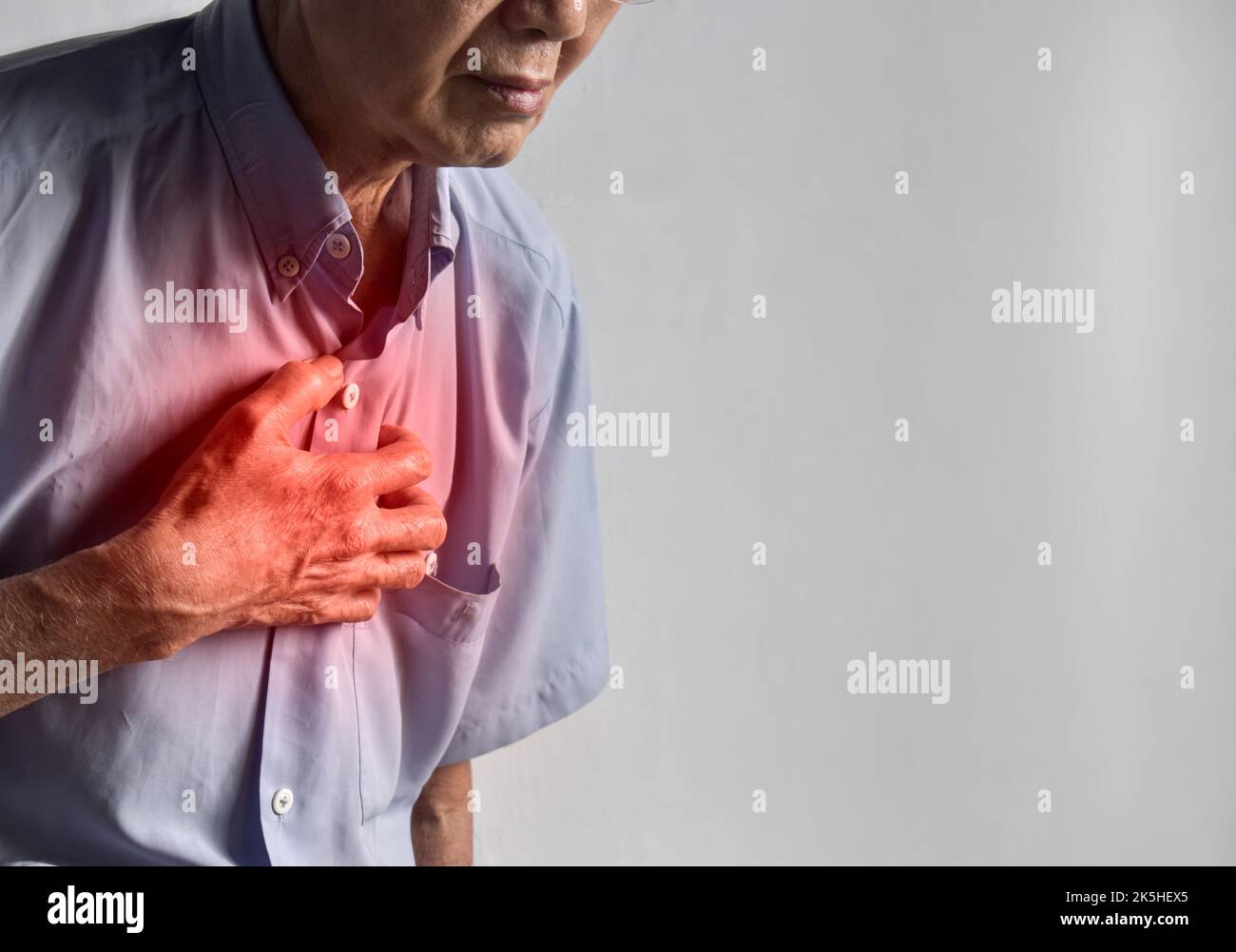 Asian elder man suffering from central chest pain. Chest pain can be