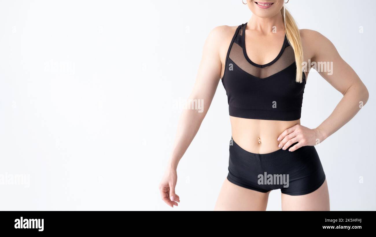 Athletic woman. Fit body. Sport and healthy lifestyle. Black crop top and shorts sportwear Stock Photo Alamy