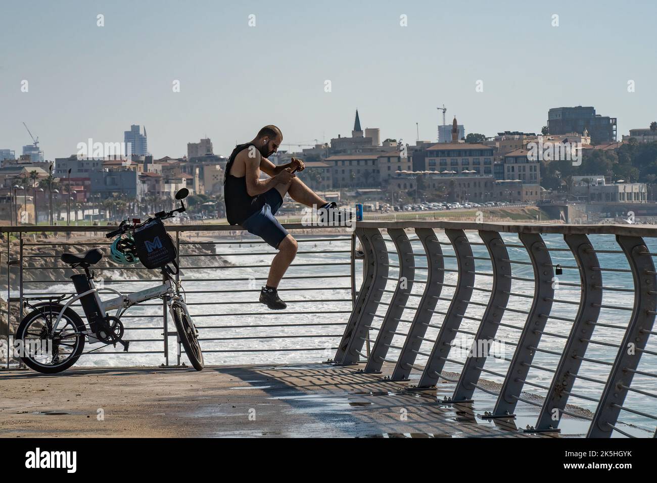 Tel Aviv, Israel - September 15th, 2022: A man resting on a boardwalk ...