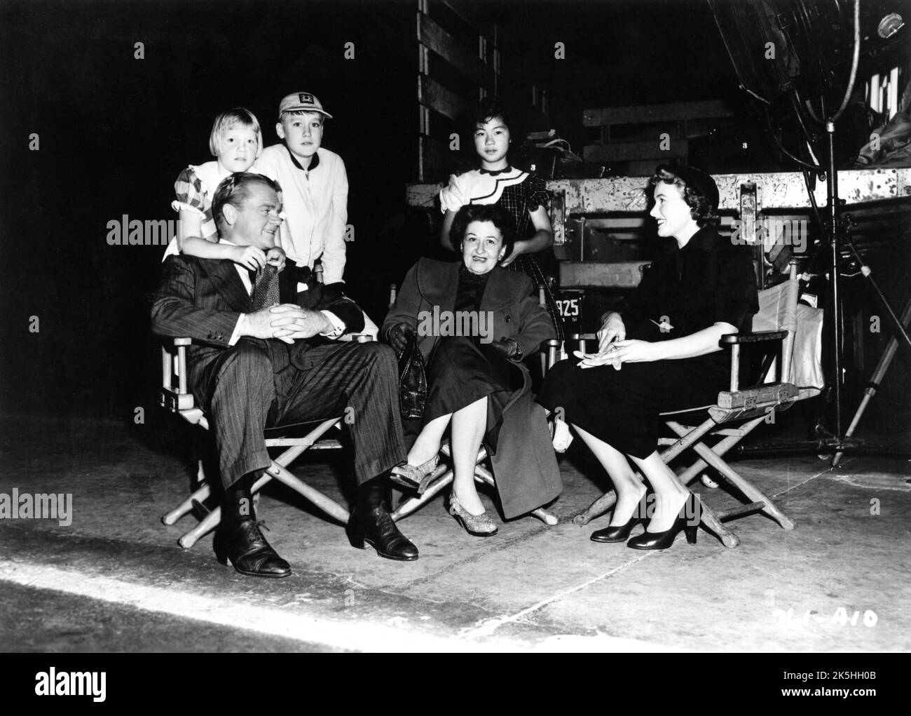 JAMES CAGNEY with his two adopted children CASEY CAGNEY and JAMES CAGNEY Jr. and wife FRANCES CAGNEY on set candid with PHYLLIS THAXTER during filming of COME FILL THE CUP 1951 director GORDON DOUGLAS novel Harlan Ware screenplay Ivan Goff and Ben Roberts producer Henry Blanke Warner Bros. Stock Photo
