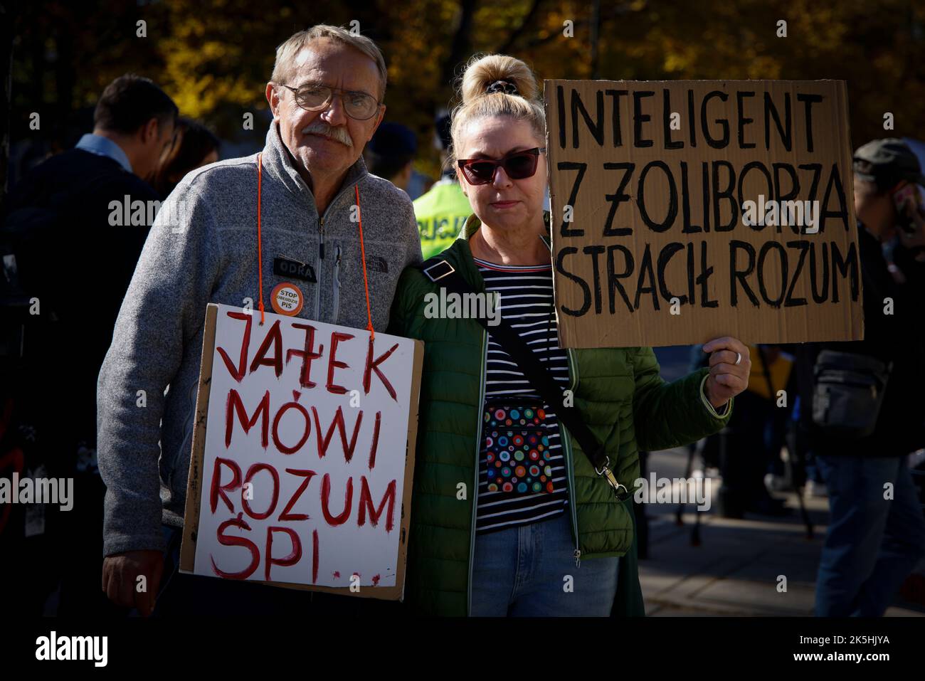 A man with a sign reading 'Jacek speaks nonsense' and a womand with a sign reading 'The intlligent man from Zoliborz has lost his mind' near the Sejm, Stock Photo