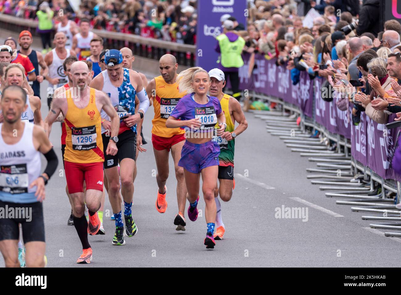 Club runners running in the TCS London Marathon 2022 road race in Tower