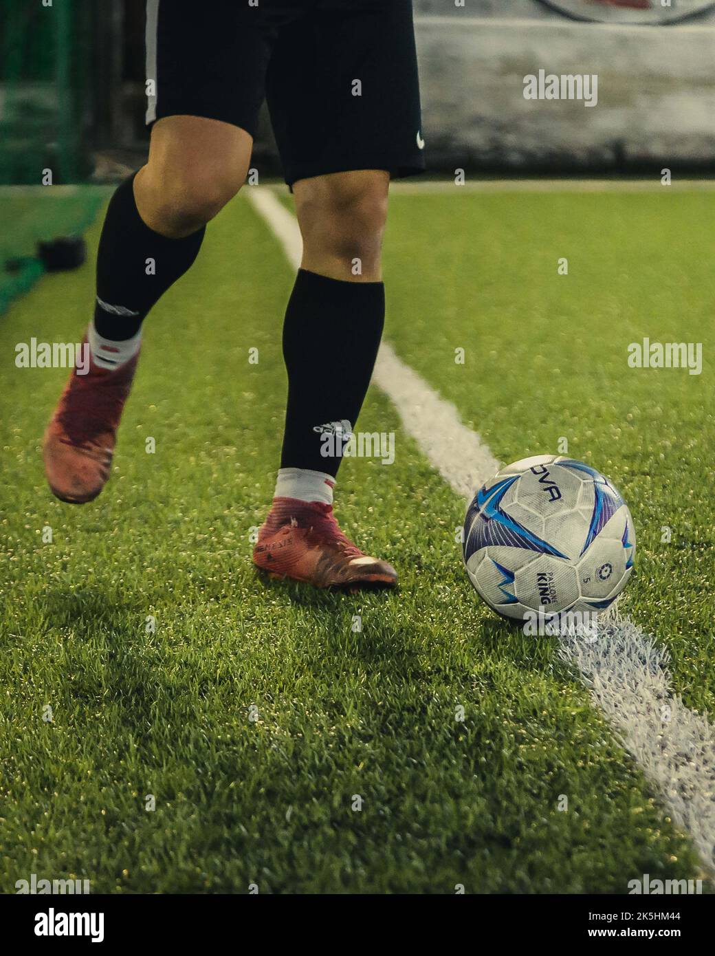 A close up of a footballer's feet and a ball in a grass field Stock ...