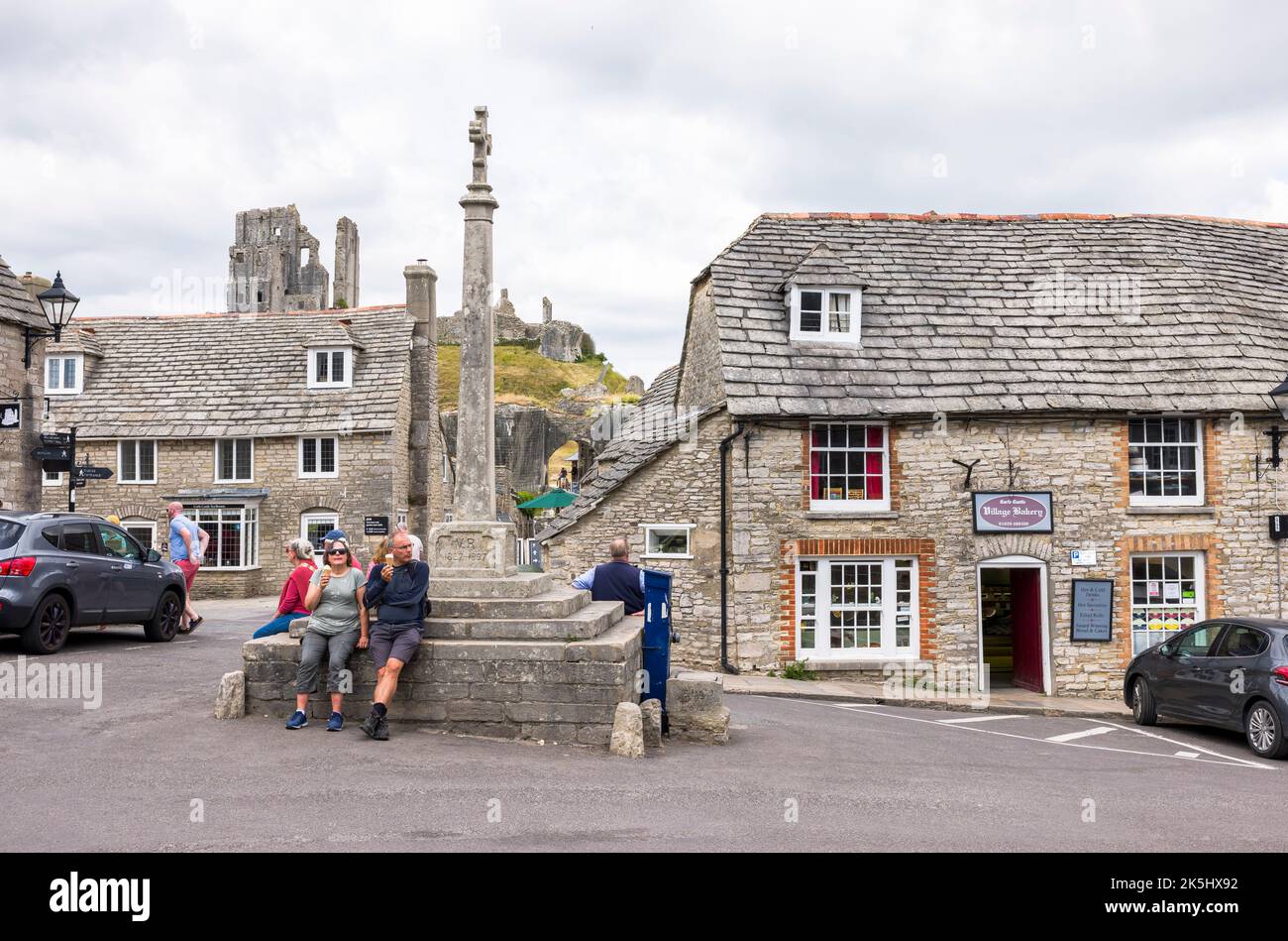 DORSET, UK - July 06, 2022. Tourists sitting on Queen Victoria Jubilee monument at Corfe Castle Village Stock Photo