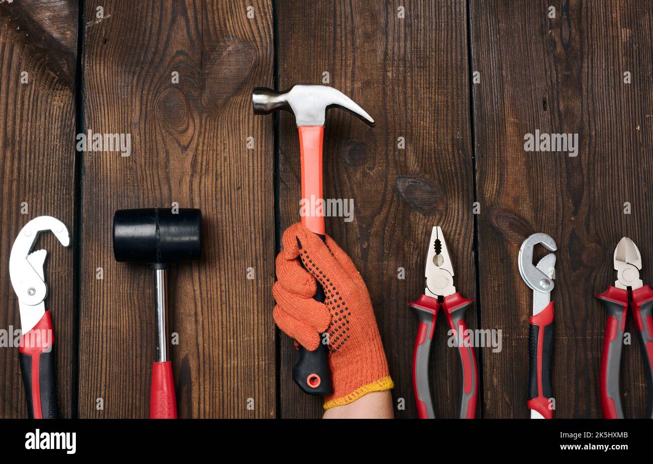 A set of construction tools on a brown wooden background, top view ...