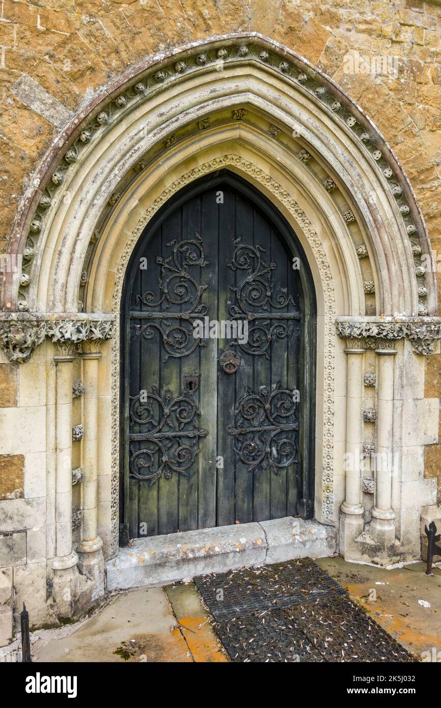 Old, ornate pointed Gothic arch church door with fleuron decorated hinges St James Church, Little Dalby, Leicestershire, England, UK Stock Photo