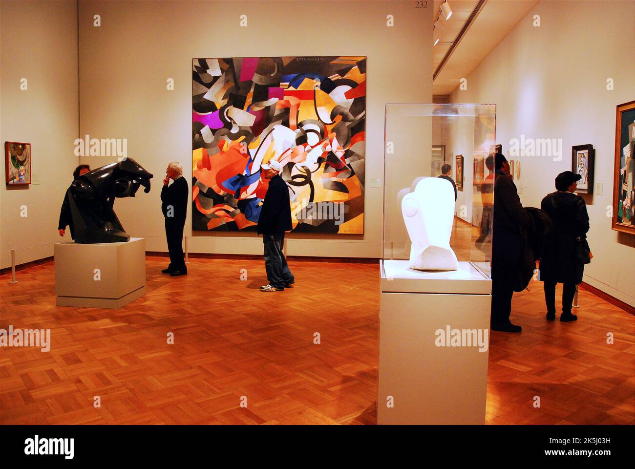 People linger in the modern art gallery of the Art Institute of Chicago, admiring the paintings and sculptures of more recent artists Stock Photo