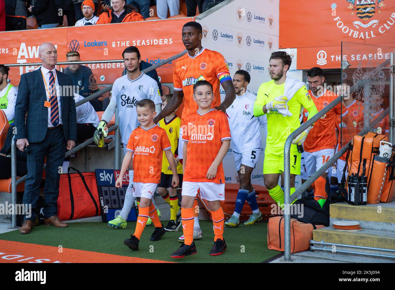 Marvin Ekpiteta #21 of Blackpool leads his side out with the team mascots ahead of the Sky Bet Championship match Blackpool vs Watford at Bloomfield Road, Blackpool, United Kingdom, 8th October 2022  (Photo by Craig Thomas/News Images) Stock Photo