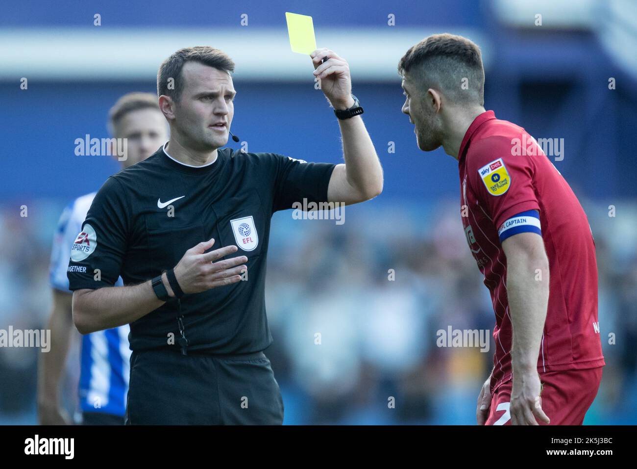 Referee Benjamin Speedie awards a yellow card to Sean Long #2 of Cheltenham Town during the Sky Bet League 1 match Sheffield Wednesday vs Cheltenham Town at Hillsborough, Sheffield, United Kingdom, 8th October 2022  (Photo by James Heaton/News Images) Stock Photo