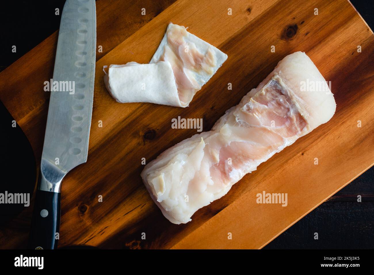 Closeup Overhead View of a Skinned Halibut Fillet on a Wood Cutting